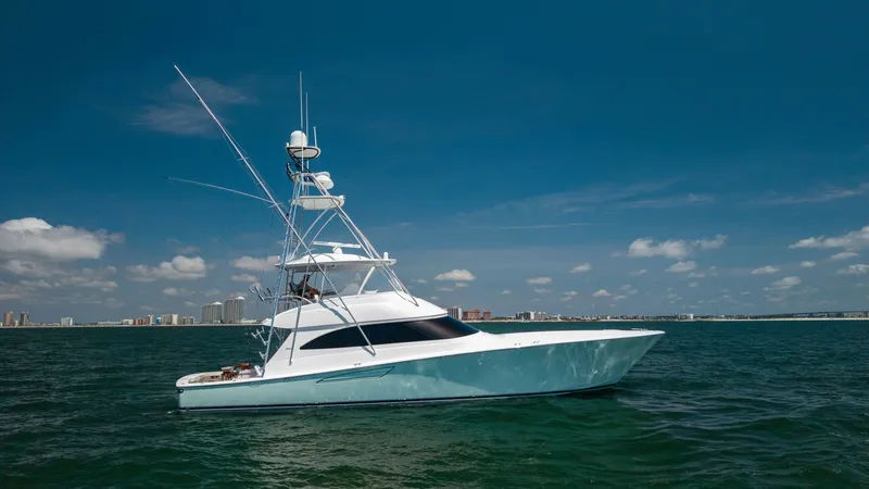 Slide: The Image of Side Profile of 62 Convertible The 2020 Viking 62 Convertible showcases its sleek lines and robust design as it glides effortlessly over the water. The side profile highlights the elegant tower and the spacious flybridge, perfect for commanding views and navigation. The hull's smooth f - 6711708