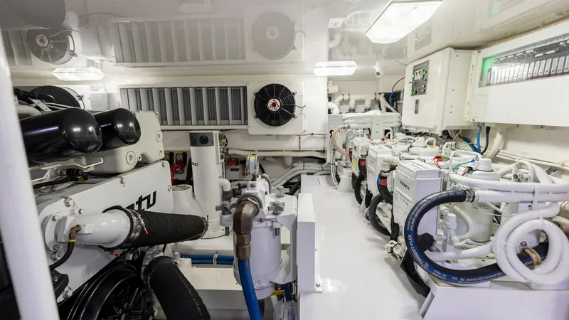Slide: The Image of Spacious Engine Room The engine room of the 2020 Viking 62 Convertible is meticulously organized, showcasing top-of-the-line equipment and efficient layout. With ample lighting and accessible control panels, maintenance and operation are streamlined for optimal performance. T - 6711707
