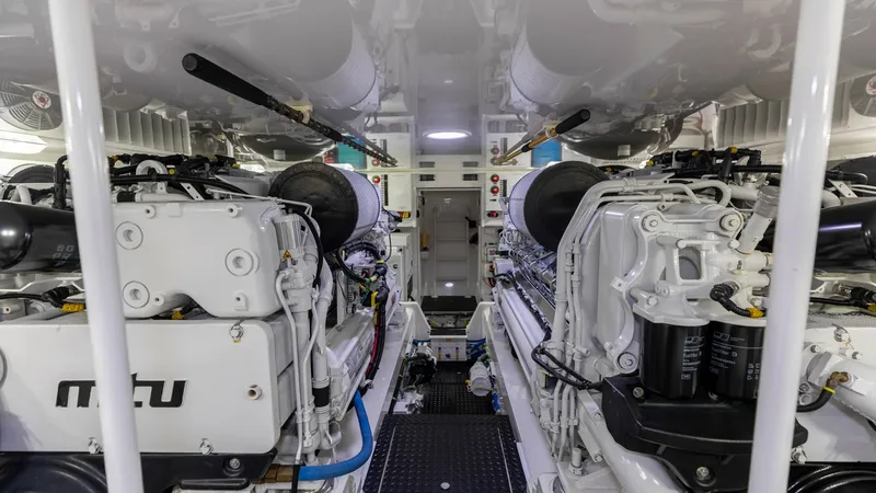 Slide: The Image of Engine Room with Twin MTU Engines This pristine engine room of the 2020 Viking 62 Convertible showcases powerful twin MTU engines, designed for optimal performance and efficiency. The space is meticulously organized, featuring advanced engineering and high-quality finishes. Ample lighting - 6711702