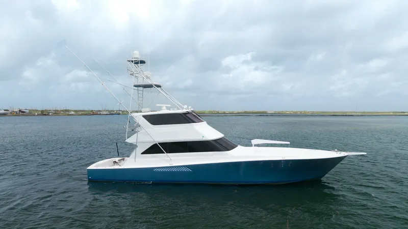 Slide: The Image of Port Side View of Viking 65 This image showcases the sleek port side of the 2001 Viking 65 Enclosed Bridge, Donna Maria. The yacht's streamlined design is complemented by a sturdy enclosed bridge, offering excellent visibility and protection from the elements. The deep blue hull con - 6767206