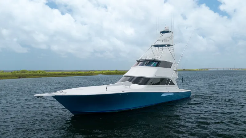 Slide: The Image of Side View of Enclosed Bridge This image showcases the sleek profile of the 2001 Viking 65 Enclosed Bridge, 'Donna Maria'. The vessel's distinctive enclosed bridge offers superior protection and visibility, ideal for all-weather navigation. The striking hull design and clean lines ref - 6767203