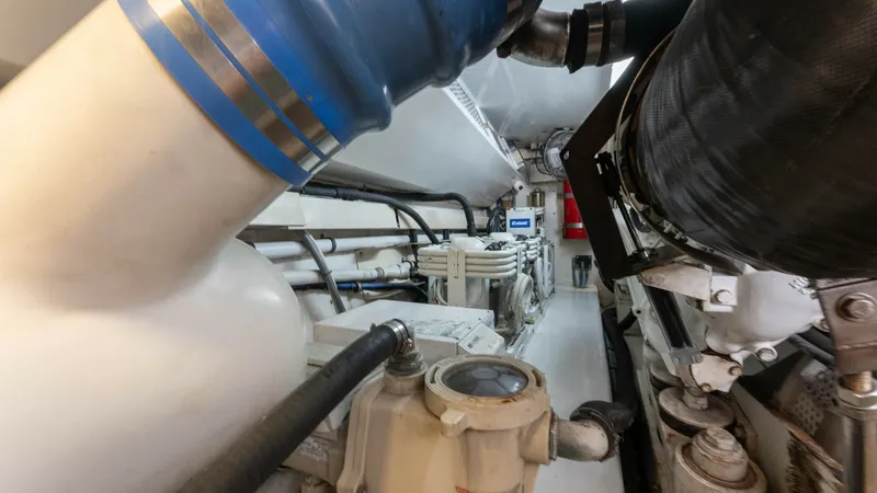 Slide: The Image of Engine Room with Advanced Machinery The engine room of the 2001 Viking 65 Enclosed Bridge 'Donna Maria' showcases robust engineering with well-organized machinery and piping. Dominated by large exhaust systems and precision components, this space is designed for optimal performance and main - 6767200