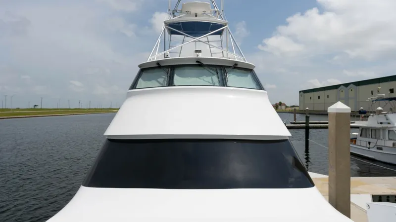 Slide: The Image of Bow View of Enclosed Bridge This image showcases the sleek and commanding bow of the Viking 65 Enclosed Bridge, highlighting its aerodynamic design. The vessel's towering enclosed bridge offers exceptional visibility and protection from the elements, making it ideal for extended voy - 6767202