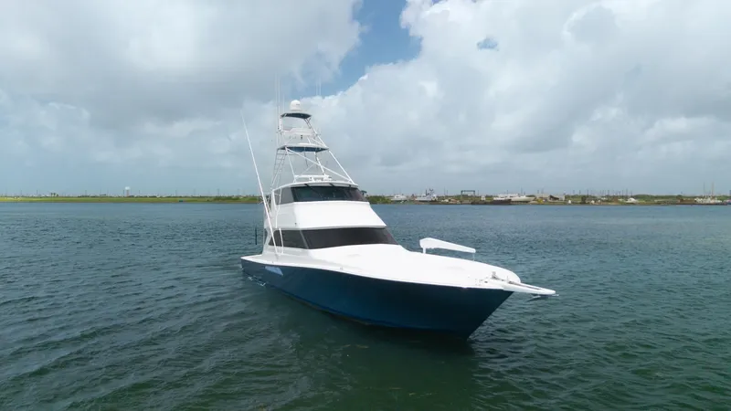 Slide: The Image of Bow View of Viking 65 Enclosed Bridge This image showcases the sleek bow of the 2001 Viking 65 Enclosed Bridge, 'Donna Maria'. The yacht's striking blue hull contrasts beautifully with the white superstructure, emphasizing its elegant design. The enclosed bridge offers a commanding view, perf - 6767205