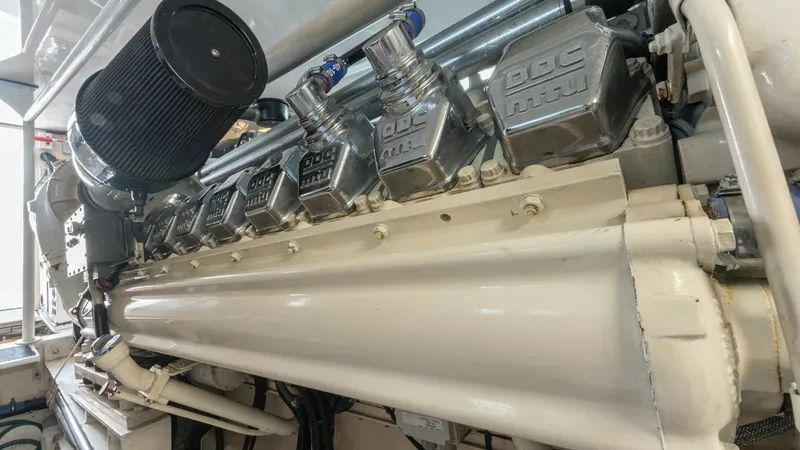 Slide: The Image of Engine Room with MTU Engine The image showcases the robust MTU engine within the engine room of the 2001 Viking 65 Enclosed Bridge. Highlighting the meticulous engineering and powerful performance, this space is essential for ensuring smooth and reliable voyages. The well-maintained - 6767197