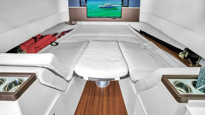 Slide: The Image of Forward Cabin Lounge Area The forward cabin of the Steel Hook'N II features a luxurious lounge area with plush white seating that can convert into a comfortable sleeping space. The wood flooring adds warmth, while the integrated flat-screen TV and sound system provide entertainmen - 6725163