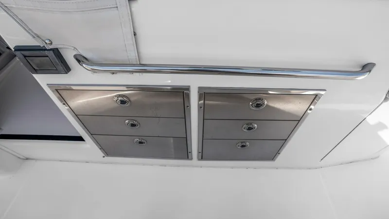 Slide: The Image of Cockpit Storage Drawers This image showcases the sleek storage drawers located in the cockpit of the 2021 Grady-White Canyon 456. The stainless steel finish provides durability and a modern look, complementing the vessel's high-quality craftsmanship. These drawers offer ample sp - 6725178