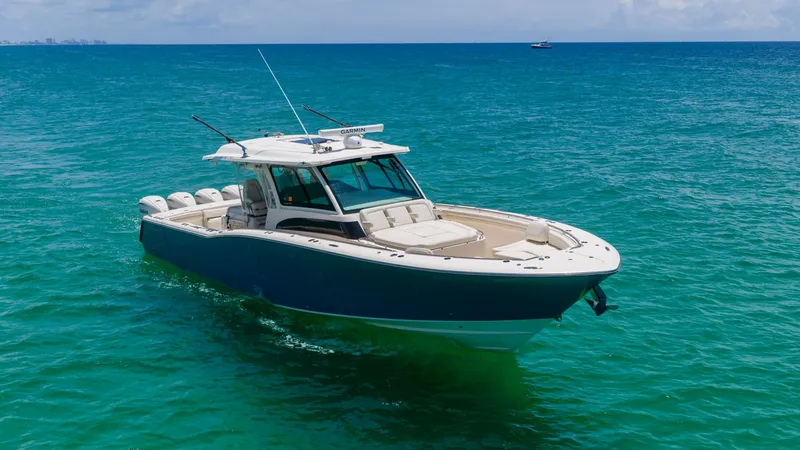 Slide: The Image of Bow View of Grady-White Canyon 456 This image showcases the sleek bow of the 2021 Grady-White Canyon 456, featuring a spacious sunpad and elegant deck design. The boat's striking blue hull contrasts beautifully with the vibrant ocean, highlighting its robust yet stylish build. With its adv - 6725200