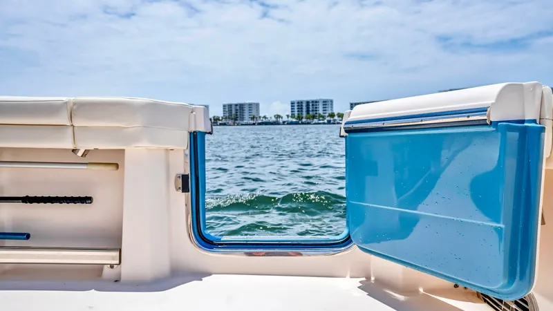 Slide: The Image of Transom Door with Ocean View This image showcases the transom door of the 2021 Grady-White Canyon 456, offering seamless access to the water. The design emphasizes convenience and functionality, ideal for fishing or leisure activities. The spacious deck area and view of the open wate - 6725187