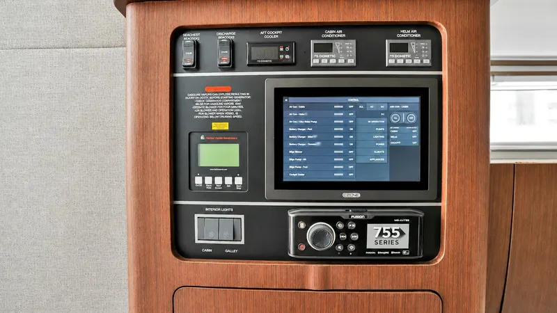 Slide: The Image of Sophisticated Control Panel This image showcases the advanced control panel of the Grady-White Canyon 456. The panel features a sleek digital interface, surrounded by finely crafted wooden finishes, offering a blend of technology and elegance. With user-friendly controls and a moder - 6725169