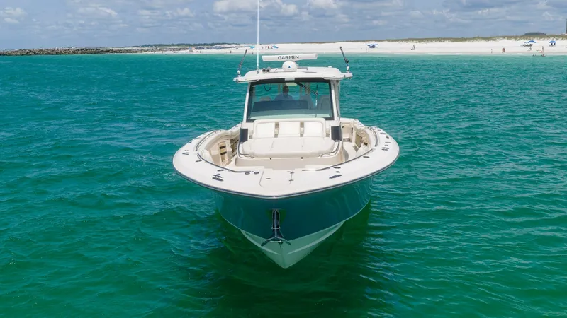 Slide: The Image of Bow View in Open Water The Grady-White Canyon 456 showcases a sleek bow design, cutting through open waters with ease. The spacious forward deck offers ample seating, perfect for enjoying panoramic ocean views. Its robust hull reflects the craftsmanship of a 2021 model, ensurin - 6725191