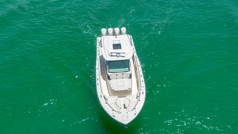 Slide: The Image of Aerial View of Bow and Deck This aerial shot showcases the sleek design of the Grady-White Canyon 456's bow and deck. The spacious layout features ample seating, perfect for relaxation and enjoying the open water. The vessel's elegant lines and robust construction are highlighted ag - 6725201