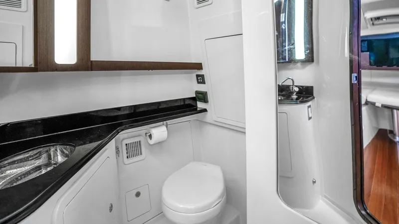 Slide: The Image of Luxurious Onboard Head This elegant onboard head features a sleek design with high-gloss finishes and modern amenities. The space is equipped with a stylish sink, ample storage, and a well-lit mirror, providing convenience and comfort. The use of premium materials and smart lay - 6725168