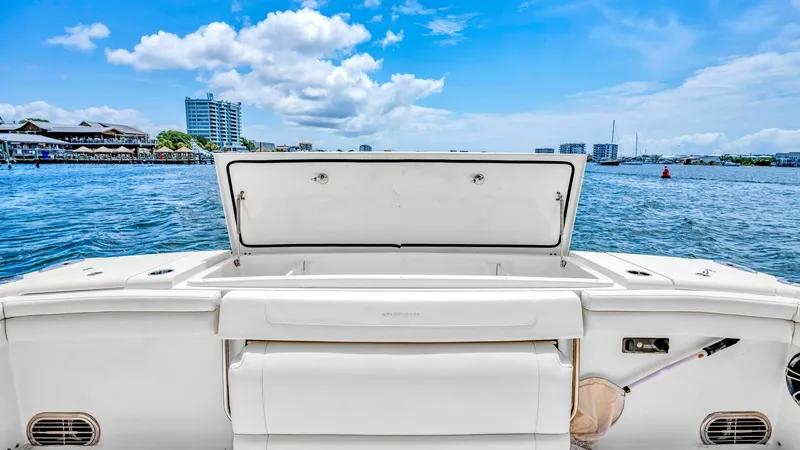 Slide: The Image of Stern Storage and Seating This image showcases the stern area of the Grady-White Canyon 456, featuring a spacious storage compartment with a neatly integrated design. The open hatch reveals ample space for storing fishing gear or other essentials, keeping the deck tidy and organiz - 6725185