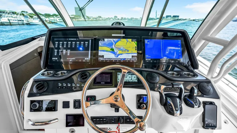 Slide: The Image of Sophisticated Helm Station View The helm station of the 2021 Grady-White Canyon 456 showcases advanced navigation technology with multiple high-resolution displays for seamless control. The ergonomic steering wheel and intuitive controls provide an unmatched captain's experience, while - 6725159