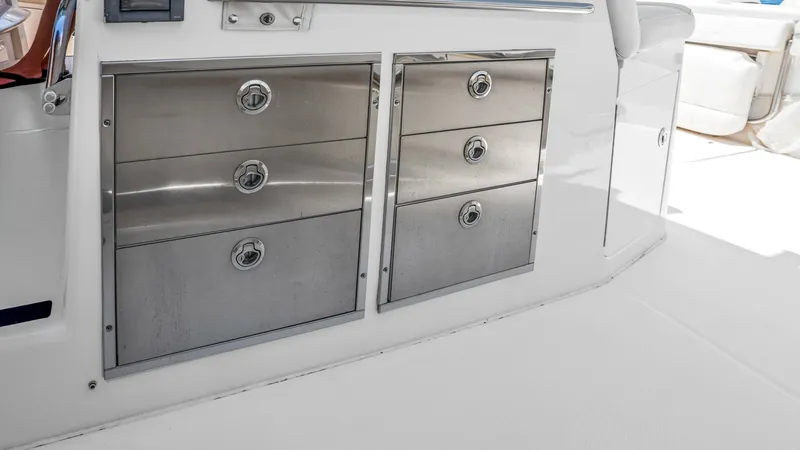 Slide: The Image of Stainless Steel Tackle Storage The image showcases the sleek, stainless steel tackle storage drawers on the Grady-White Canyon 456. These robust compartments are designed for durability and easy organization of fishing gear. Positioned conveniently on the deck, they provide seamless ac - 6725177
