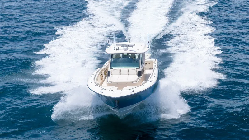 Slide: The Image of Dynamic Bow View in Motion The Grady-White Canyon 456 cuts through the water with power and elegance, showcasing its robust bow design. The spacious deck is visible, providing ample seating and a flawless blend of luxury and functionality. The crisp, clean lines and superior crafts - 6725197