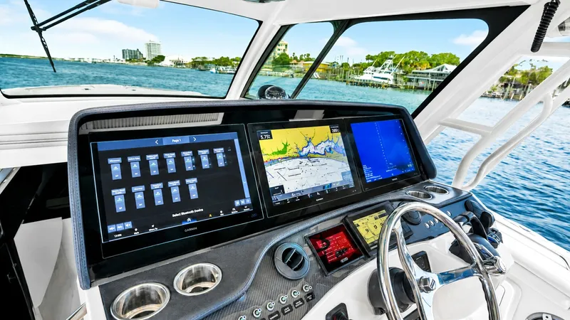 Slide: The Image of Helm Station with Dual Displays The helm station of the 2021 Grady-White Canyon 456 showcases state-of-the-art dual navigation displays, offering seamless control and monitoring capabilities. Surrounded by sleek, modern finishes, the dashboard features intuitive controls and a stainless - 6725157