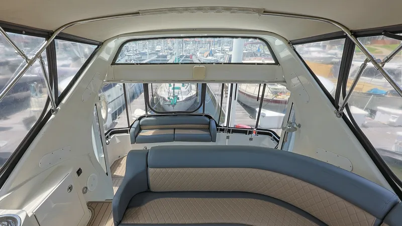 Slide: The Image of Flybridge Seating Area The flybridge of the 2006 Carver 396 Motor Yacht offers a spacious seating area with plush, cushioned benches. Surrounded by panoramic windows, this space provides stunning views while cruising or docked. The combination of comfort and visibility makes it - 8273159