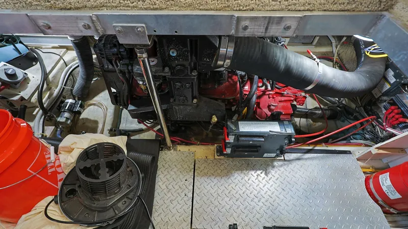 Slide: The Image of Engine Room with Mechanical Systems This image showcases the well-organized engine room of the 2006 Carver 396 Motor Yacht, Serendipity. Prominent features include the powerful engine and neatly arranged wiring and components, highlighting the vessel's robust mechanical systems. The diamond - 8273182