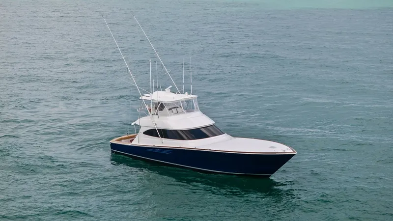 Slide: The Image of Aerial View of Viking 64 Convertible The 2024 Viking 64 Convertible, 'Southern Grace', showcases its sleek design and powerful presence on the open water. The vessel features a distinctive deep blue hull and a spacious flybridge equipped with advanced navigation systems. Its elegant profile - 7541891