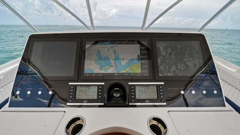 Slide: The Image of Helm Station with Navigation Displays The helm station of the 2024 Viking 64 Convertible 'Southern Grace' showcases state-of-the-art navigation technology with an array of multifunctional displays. The clean, modern design features intuitive controls and advanced electronics, providing an opt - 7541860