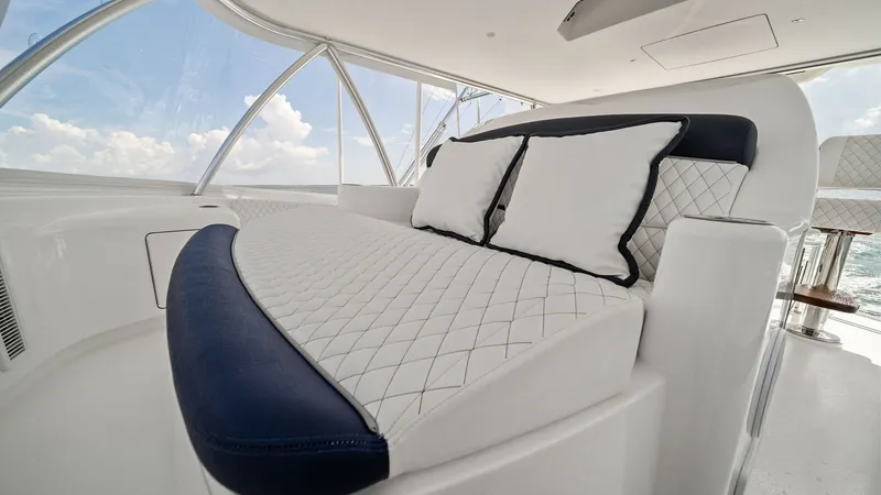 Slide: The Image of Flybridge Lounge Seating Area The flybridge of the 2024 Viking 64 Convertible features a luxurious lounge seating area with plush, quilted cushioning and elegant navy accents. The expansive windows offer panoramic views, enhancing the open and airy ambiance. This space is perfect for - 7541868