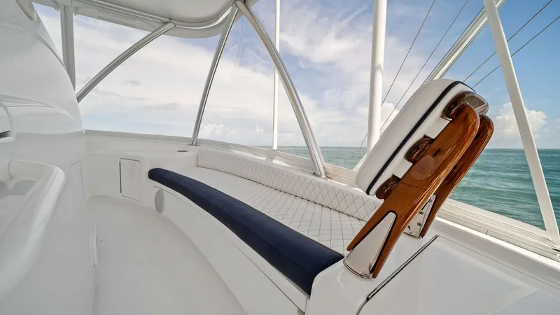 Slide: The Image of Flybridge Seating Area with Helm Chair The flybridge of the 2024 Viking 64 Convertible, Southern Grace, offers a spacious seating area with plush, diamond-stitched upholstery. The helm chair features a polished wooden finish, providing both comfort and style for navigating open waters. Expansi - 7541866