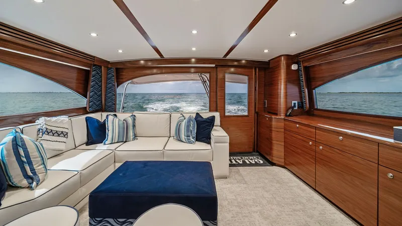 Slide: The Image of Salon with Panoramic Ocean Views This luxurious salon on the 2024 Viking 64 Convertible 'Southern Grace' features elegant wood finishes and plush seating. Large windows provide stunning panoramic views of the ocean, enhancing the open and airy feel. The space is beautifully appointed wit - 7541827