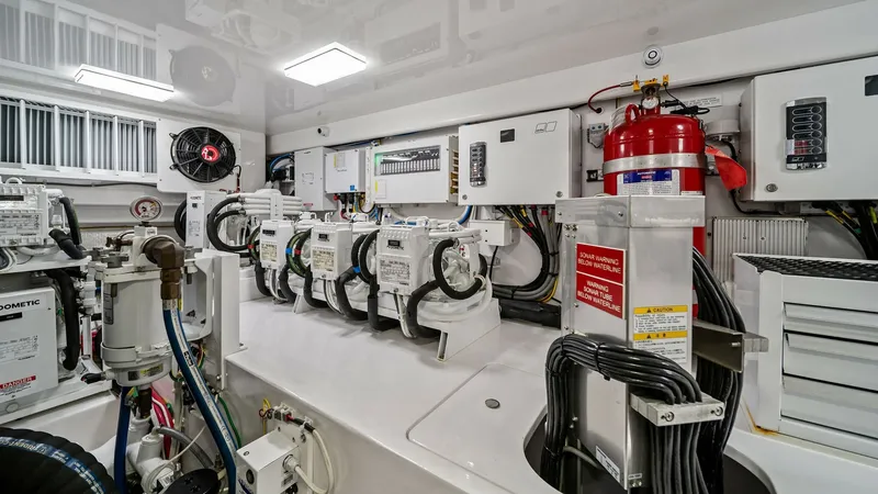 Slide: The Image of Engine Room with Advanced Systems The engine room of the 2024 Viking 64 Convertible 'Southern Grace' showcases state-of-the-art systems and meticulously organized equipment. Highlighted by pristine white finishes, this space features advanced electrical and mechanical components, ensuring - 7541877