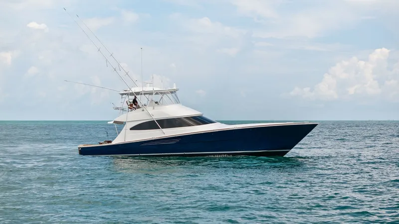 Slide: The Image of Side Profile on Open Water The 2024 Viking 64 Convertible, Southern Grace, is elegantly showcased in this side profile view, cruising smoothly on open waters. Its sleek hull design and striking blue finish highlight the vessel's modern aesthetic and superior craftsmanship. The flyb - 7541893
