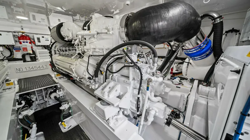 Slide: The Image of Engine Room with Twin Engines The engine room of the 2024 Viking 64 Convertible, Southern Grace, showcases powerful twin engines designed for high performance and efficiency. The space is meticulously organized, featuring advanced engineering and state-of-the-art systems. Bright light - 7541874