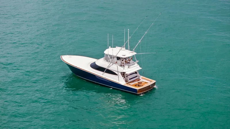 Slide: The Image of Aerial View of Sport Fishing Deck This image showcases the impressive sport fishing deck of the 2024 Viking 64 Convertible, Southern Grace. The spacious teak-lined cockpit is equipped with state-of-the-art fishing amenities, providing ample space for anglers. The sleek design and superior - 7541889
