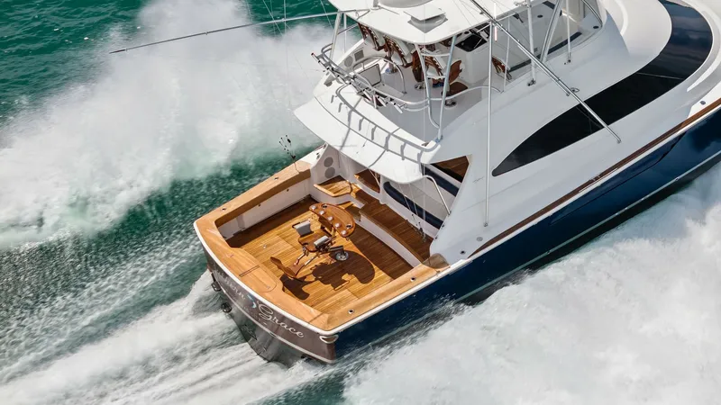 Slide: The Image of Aerial View of Aft Deck in Motion The 2024 Viking 64 Convertible, Southern Grace, showcases a stunning aft deck from an aerial perspective as it cuts through the water. The teak decking provides a luxurious finish, while the spacious layout is perfect for outdoor gatherings or serious fis - 7541902