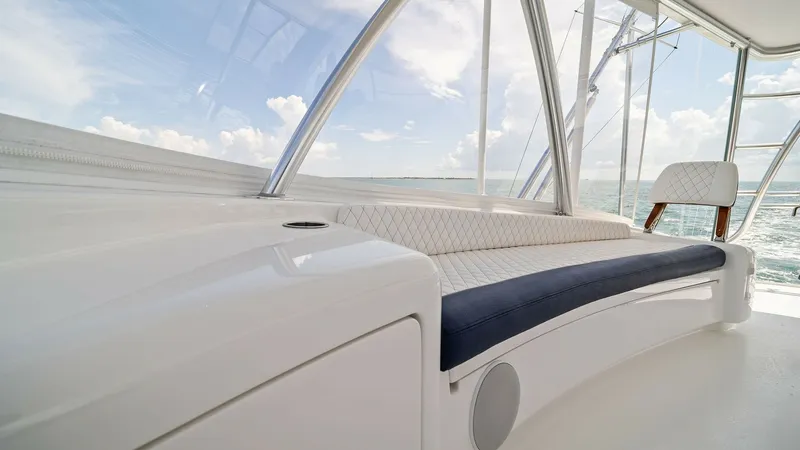Slide: The Image of Flybridge Seating Area with Ocean View This image showcases the elegant flybridge seating area of the 2024 Viking 64 Convertible, Southern Grace. The plush, diamond-stitched upholstery offers comfort while providing panoramic ocean views through the expansive windows. The sleek, modern design - 7541869