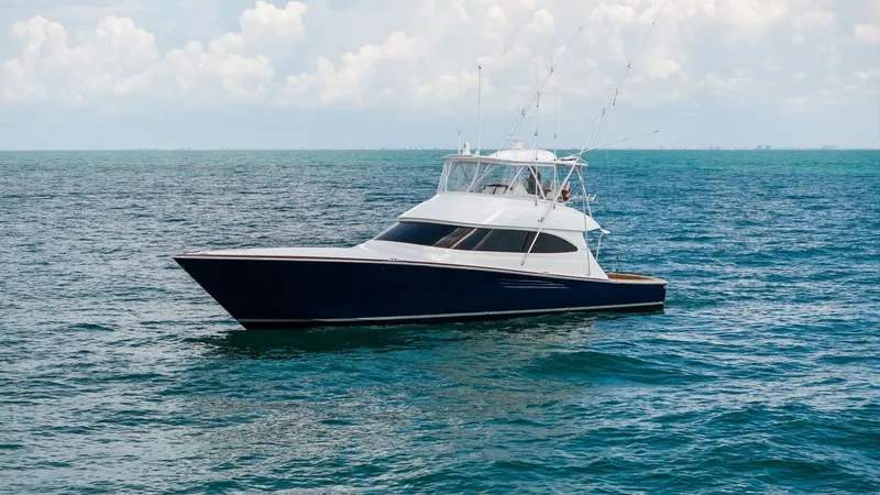 Slide: The Image of Starboard Profile of Viking 64 Convertible The 2024 Viking 64 Convertible, Southern Grace, showcases a sleek starboard profile with its deep blue hull cutting through the ocean effortlessly. Its aerodynamic design and spacious flybridge are highlighted, providing an ideal vantage point for fishing - 7541886
