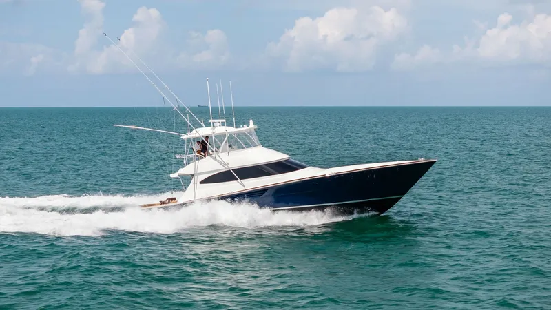 Slide: The Image of Viking 64 Convertible Cruising The 2024 Viking 64 Convertible 'Southern Grace' showcases its sleek profile as it cruises effortlessly through open waters. This vessel features a striking hull design with a sharp bow and a spacious flybridge, ideal for both fishing and leisure. Its powe - 7541904