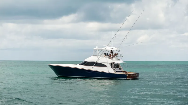 Slide: The Image of Side Profile of Viking 64 Convertible The Southern Grace, a 2024 Viking 64 Convertible, showcases its sleek profile against a serene seascape. Notable for its elegant design, the vessel features a spacious flybridge and a robust fishing setup, ideal for offshore adventures. The dark hull cont - 7541888