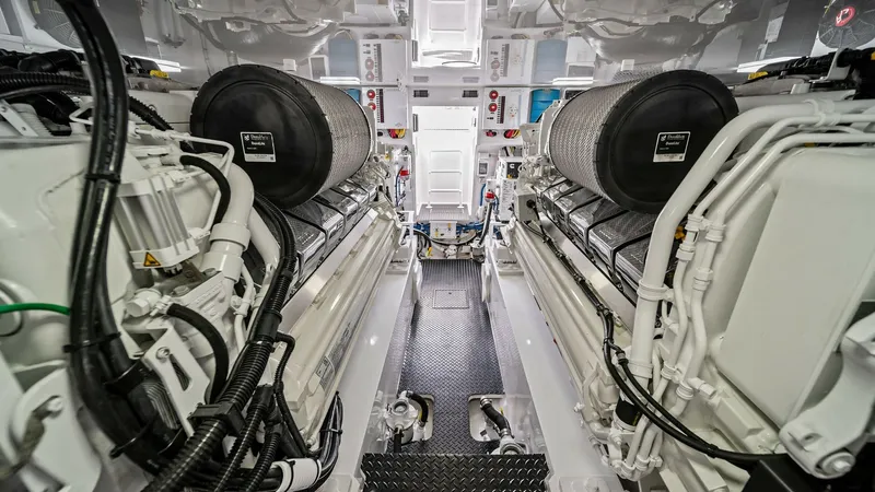 Slide: The Image of Engine Room with Twin Engines The engine room of the 2024 Viking 64 Convertible 'Southern Grace' showcases its powerful twin engines, meticulously arranged for optimal performance and accessibility. The clean, spacious layout is accentuated by high-quality materials and advanced engin - 7541879