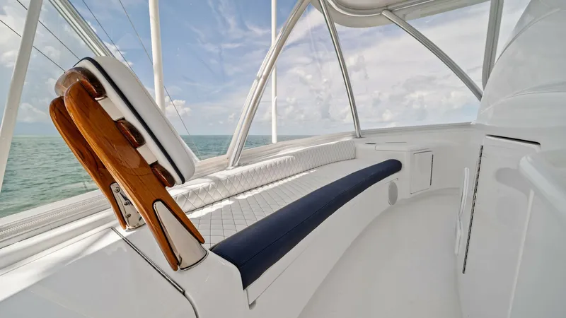Slide: The Image of Flybridge Helm Seating Area The flybridge of the 2024 Viking 64 Convertible features a sleek helm seating area with a commanding view of the surroundings. The seating is upholstered in premium materials, offering both comfort and style, while the polished wood accents add a touch of - 7541865