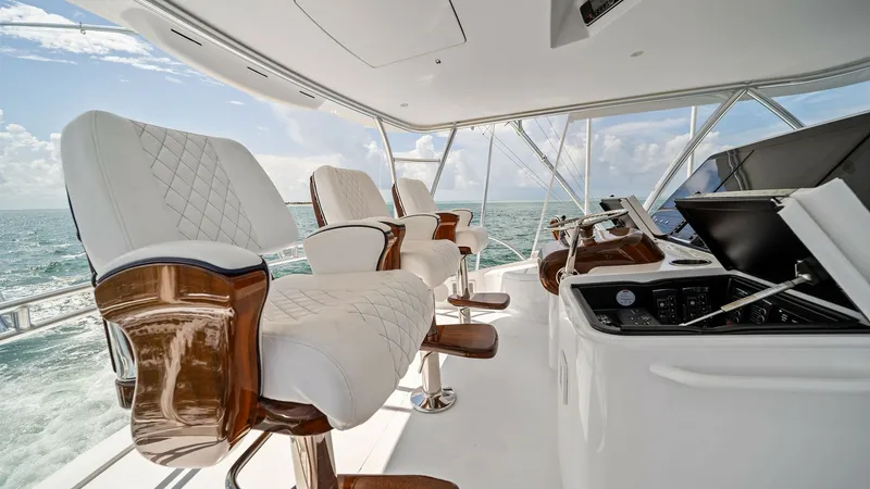 Slide: The Image of Flybridge Helm Seating Area The flybridge of the Southern Grace offers luxurious helm seating with plush, diamond-stitched upholstery and rich wooden accents. The spacious layout provides a commanding view, complemented by state-of-the-art navigational equipment. Perfectly designed - 7541863