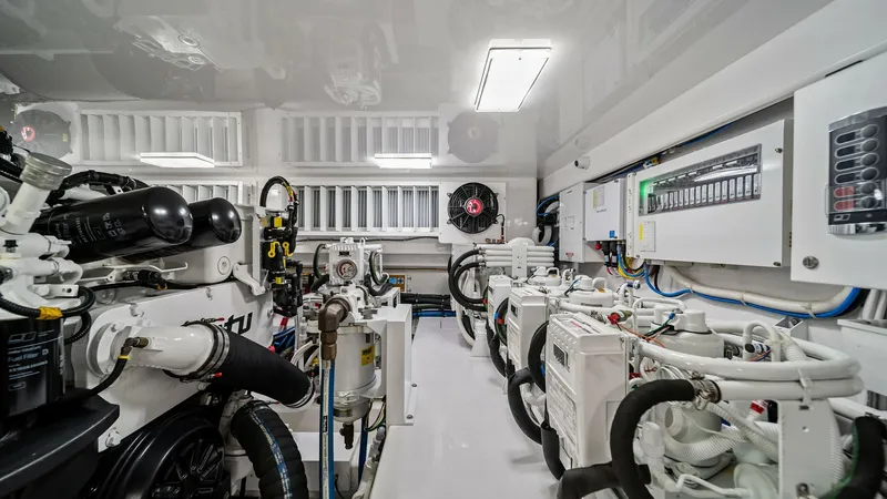 Slide: The Image of Engine Room with Advanced Systems The engine room of the 2024 Viking 64 Convertible, Southern Grace, showcases state-of-the-art machinery and systems. Featuring meticulously arranged components, this space ensures peak performance and reliability. Bright lighting and organized layout emph - 7541881