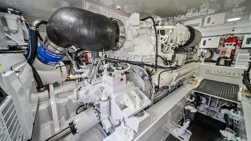 Slide: The Image of Engine Room with Advanced Machinery The engine room of the 2024 Viking 64 Convertible 'Southern Grace' showcases robust and meticulously arranged machinery, featuring high-performance engines for optimal power. The space is designed for easy access and maintenance, with clean lines and a pr - 7541873