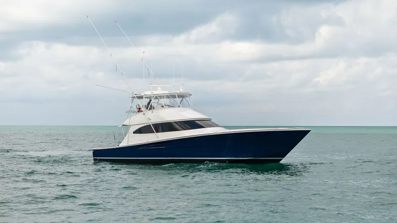 Slide: The Image of Side Profile of 64 Convertible The Viking 64 Convertible showcases a sleek and powerful side profile, cutting through the water with its deep blue hull. The vessel's commanding flybridge offers expansive views and is equipped with advanced navigation systems. Its modern design and robu - 7541890