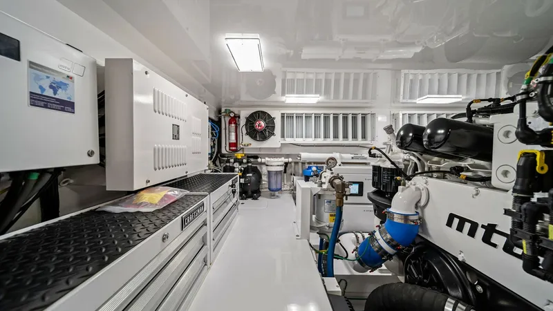 Slide: The Image of Engine Room with MTU Engines The engine room of the 2024 Viking 64 Convertible 'Southern Grace' showcases advanced MTU engines, offering robust performance. The space is meticulously organized, featuring stainless steel tool storage and efficient lighting for optimal visibility and m - 7541880