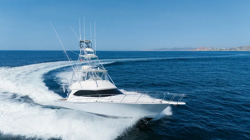 Slide: The Image of 2009 Viking 50 Convertible "Jammin" - Starboard Bow View Highlighting the Yacht's Graceful Profile and On-Water Presence. The 2009 Viking 50 Convertible, Jammin, gracefully cuts through the water, showcasing its sleek and powerful design. The prominent bow and flybridge command attention, while the vessel's elegant lines highlight its superior craftsmanship. This image captu - 7018225