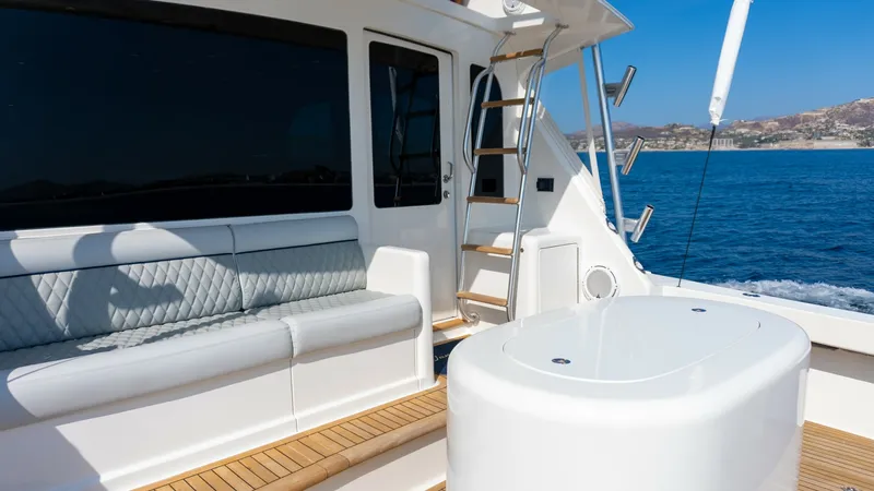 Slide: The Image of 2009 Viking 50 Convertible "Jammin" - Spacious Aft Deck The aft deck of the 2009 Viking 50 Convertible 'Jammin' features comfortable bench seating with elegant upholstery, perfect for relaxing while enjoying the open sea. The teak decking adds a touch of luxury and durability, complementing the sleek lines of - 7018210