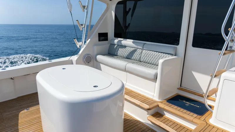 Slide: The Image of 2009 Viking 50 Convertible "Jammin" - Cockpit Seating Area with Tackle Center This inviting cockpit of the 2009 Viking 50 Convertible features a comfortable seating area with a sleek, cushioned bench perfect for relaxation. The area is complemented by a modern tackle center for convenient storage and organization of fishing gear. T - 7018208