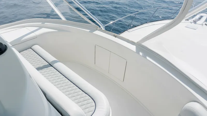 Slide: The Image of 2009 Viking 50 Convertible "Jammin" - A Beautifully Appointed Flybridge Lounge offering the Perfect Blend of Comfort, Open-Air Living, and Panoramic Views for Unforgettable Moments Underway or at Anchor. The flybridge of the 2009 Viking 50 Convertible offers a spacious seating area with plush, diamond-stitched upholstery, providing comfort and style. The clean white finish complements the sleek design, while the surrounding glass offers unobstructed panor - 7018184