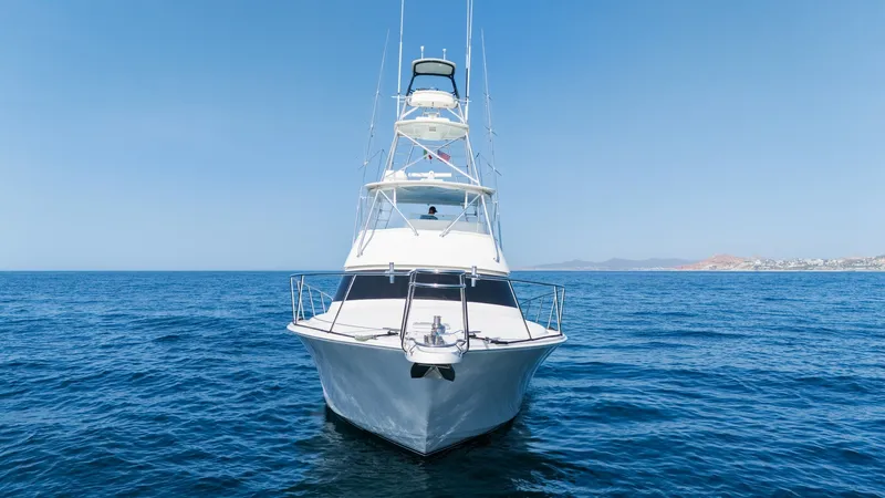 Slide: The Image of 2009 Viking 50 Convertible "Jammin" - Where Elegance Begins The sleek bow of the 2009 Viking 50 Convertible, 'Jammin', is showcased against the open sea. With its sharp lines and robust railing, the vessel exudes confidence and style. The towering flybridge adds to its commanding presence, offering panoramic views - 7018174